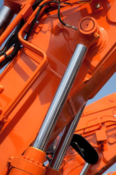 Closeup view of an orange hydraulic system