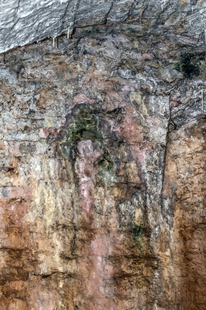 istock Light gray-brown stone texture with stalactites on the surfaces 1370921128