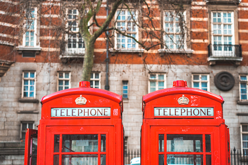 Close up of 2 vintage red telephone boxes, London