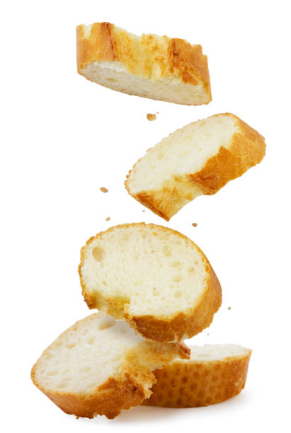 istock Sliced baguette falls on a pile on a white background. Isolated 1370922245