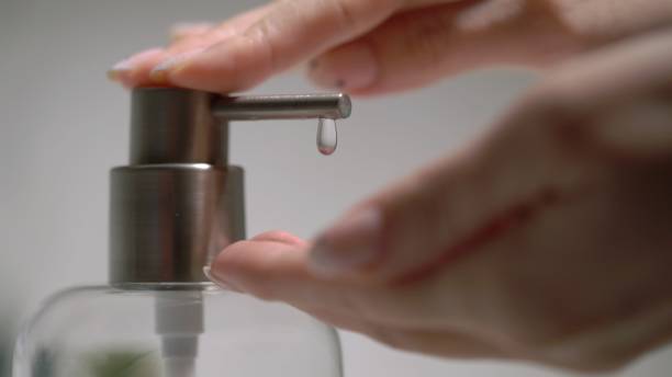 istock A woman uses a dispenser with antibacterial soap or antiseptic 1370922260