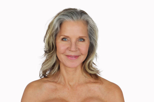 Pretty mature woman smiling with bare shoulders