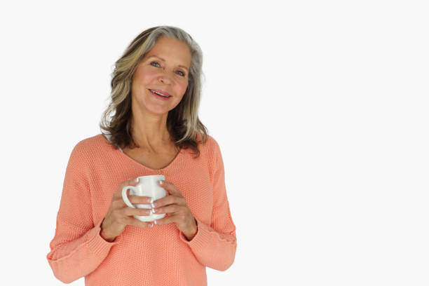 istock Smiling older woman holding coffee cup 1370922906