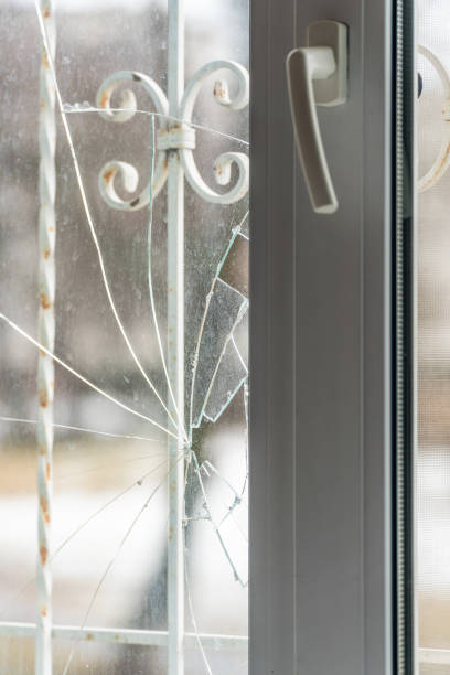 istock Glass broken by hooligans in a metal-plastic window, close-up 1370924197
