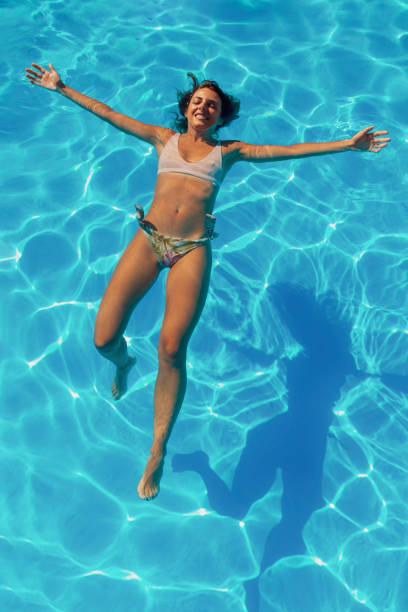 Woman swimming in  pool at tourist resort on Ko Phangan, Thailand