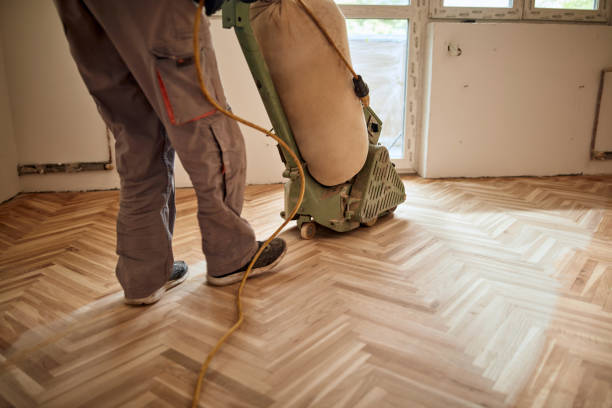 istock Repairman restoring parquet with a sanding machine. 1370925798