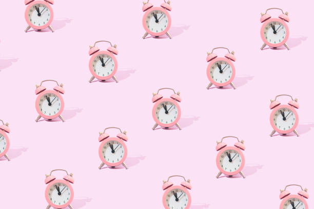 istock Retro aesthetic pink clock on a pastel purple background. 1370927173