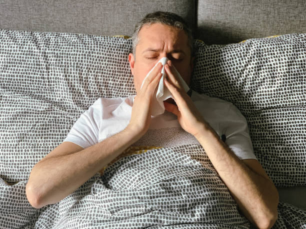 istock Middle aged man is sick at home, having flu or hangover 1370927228