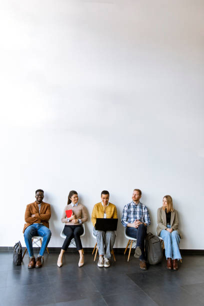 Group of bored people waiting for the job interview stock photo