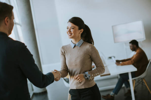 istock Young business partners making handshake in an office 1370930023