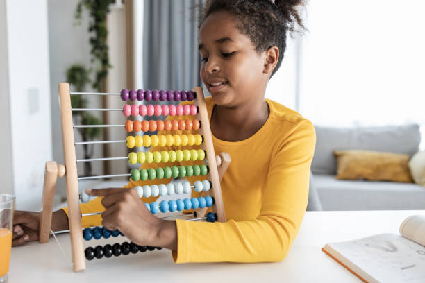 istock Young African American girl using colorful abacus 1370931364