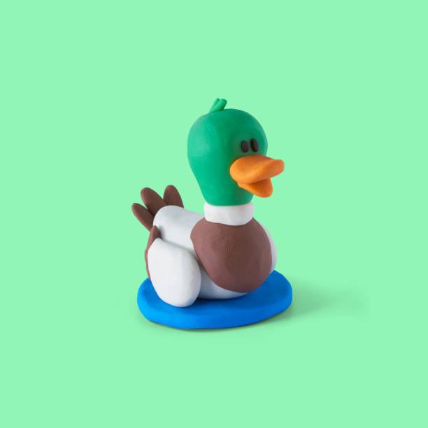 Beautiful duck made of plasticine on a green background
