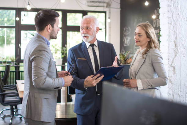 istock Business partners having conversation in office 1370932631