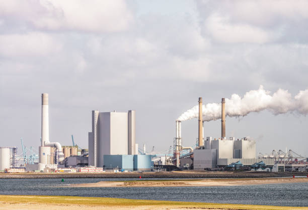 Sun sets over a steel manufacturing mill in Hamilton Ontario, Canada. Photograph shows the manufacturing facility as seen from across the bay.
