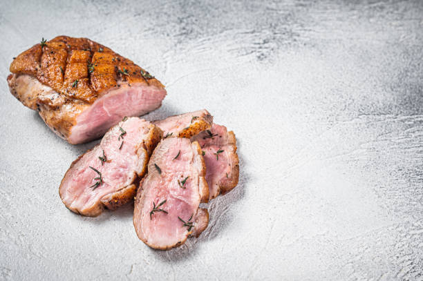 istock Roasted Sliced Duck breast fiilet steak. White background. Top view. Copy space 1370937164