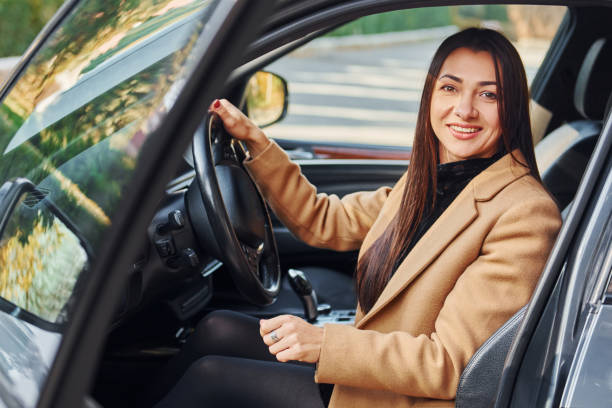 istock Woman is sitting in modern black colored automobile 1370937337