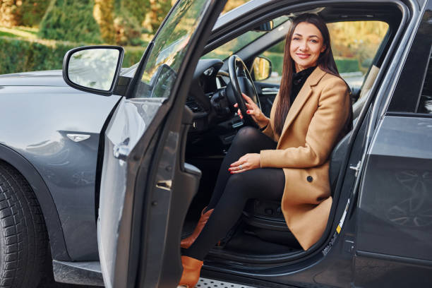 istock Woman is sitting in modern black colored automobile 1370937373