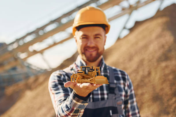 istock Positive man. Construction worker in uniform is on the quarry 1370938349