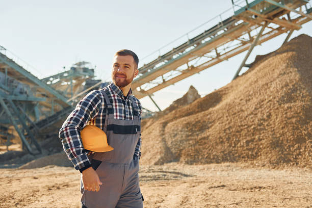istock Smart person. Construction worker in uniform is on the quarry 1370938380