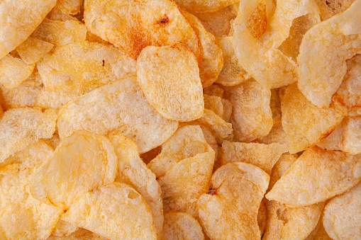 Full-frame close-up of a stack of chips. This image can be used as a background.