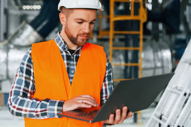 istock Close up view. Construction worker in uniform is in the factory 1370938511