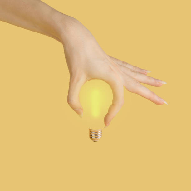 istock The hand makes the shape of a light bulb on a yellow background. 1370938826