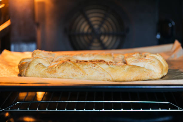 istock Homemade apple pie baking in oven at kitchen 1370939730