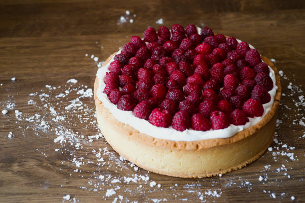 istock Raspberry and cream cake on a wooden table 1370939838