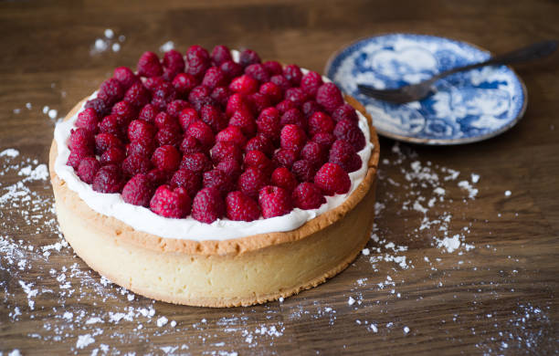 istock Raspberry cake and blue porcelain plate on wooden table 1370939930