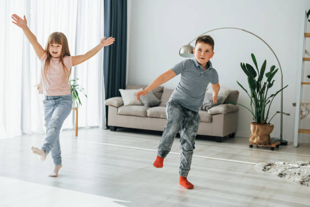 istock Active weekend time spending. Kids having fun in the domestic room at daytime together 1370939993