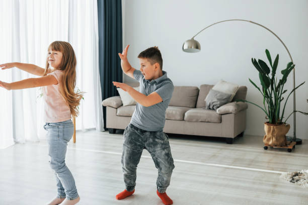 istock Active weekend time spending. Kids having fun in the domestic room at daytime together 1370939996