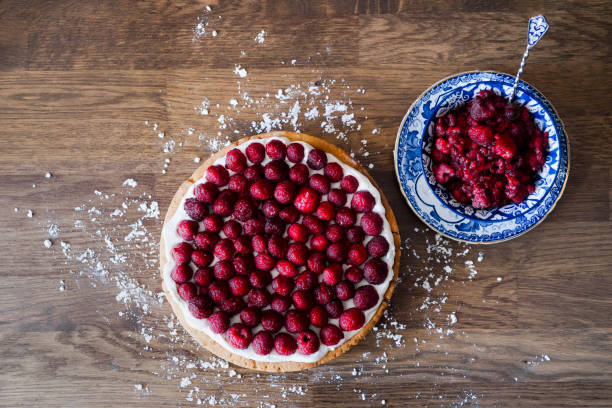 istock Raspberry cake and blue porcelain  bowl filled with raspberries on a wooden table 1370940085