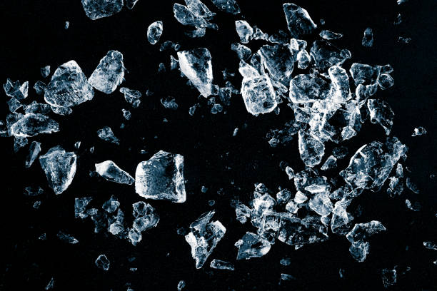 istock Pieces of crushed ice cubes on black background. Ice debris pattern. 1370945172