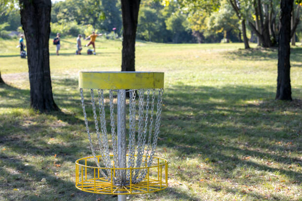istock People playing flying disc golf sport game in the park 1370946879