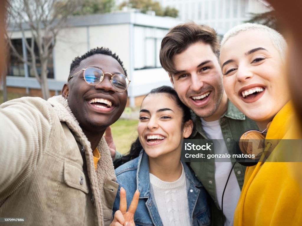 POV of a group of smiling teenage multicultural best friends taking a selfie. POV of a group of smiling teenage multicultural best friends taking a selfie. Funny friends, celebrating a party. Happiness and friendship concept. High quality photo Teenagers Only Stock Photo