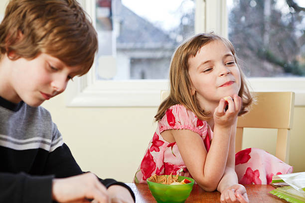 istock Happy Young Girl Eating at Table 137094809