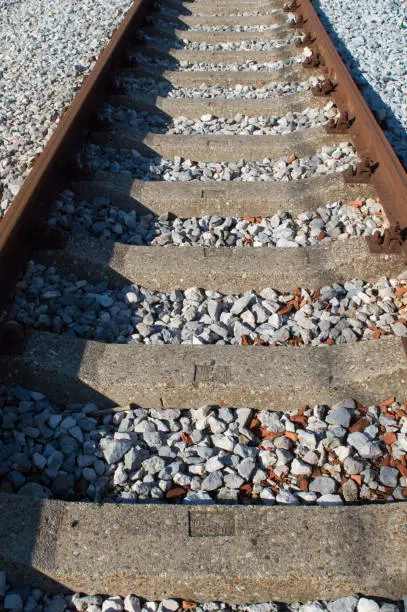 Empty railway tracks with concrete sleepers, in the countryside