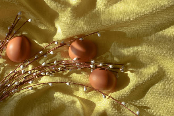 istock Happy Easter. Beautiful decoration for the spring holiday. Chicken eggs and willow on a yellow background in the rays of the sun. 1370949120