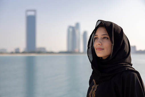 Portrait of a beautiful Midlle Eastern woman outdoors in Dubai wearing a black hijab