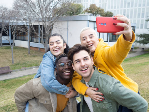 istock Group of multicultural college student friends taking a selfie on campus 1370949751