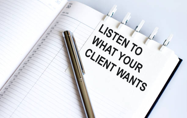 istock text LISTEN TO WHAT YOUR CLIENT WANTS on the short note texture background with pen 1370951682
