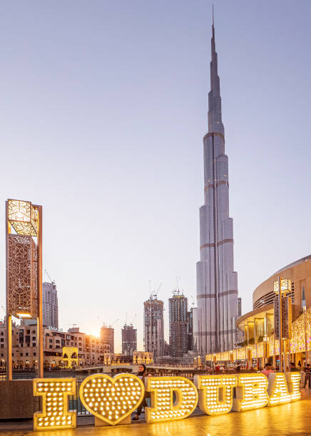 Dubai Dubai, UAE - January 20, 2018: view of the iconic architecture of Dubai in the United Arab Emirates at night by the Dubai Mall with the Burj Khalifa building on the background and lot of tourists and locals enjoying themselves. dubai mall stock pictures, royalty-free photos & images