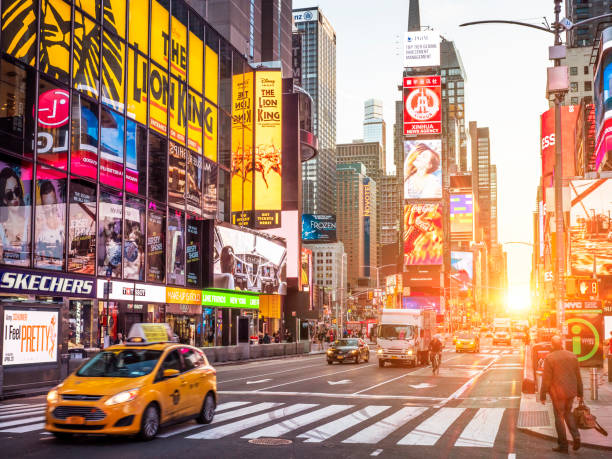 New York New York, NY, USA - June 10, 2018: view of the iconic architecture of New York city in the USA showcasing the famous Times Square with its neon lights, stores, and restaurants with lots of locals and tourists passing at night. times square manhattan stock pictures, royalty-free photos & images