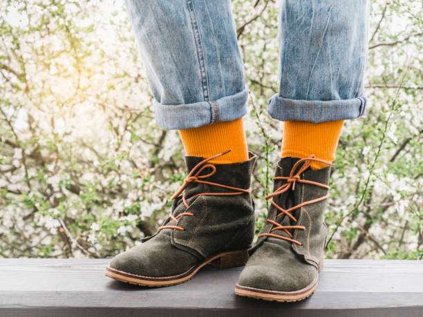 istock Trendy boots and colorful socks. Day light 1370953688