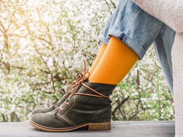 istock Trendy boots and colorful socks. Day light 1370954269