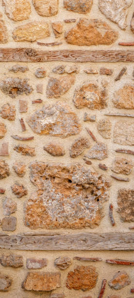 istock background, texture - rough masonry from wild stone and cement on a wooden frame