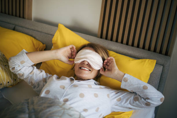 istock senior woman wearing sleep mask 1370955557