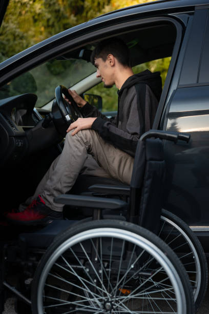 istock A real disabled person in a wheelchair communicates with the world through electronic devices, computer, telephone. 1370956814