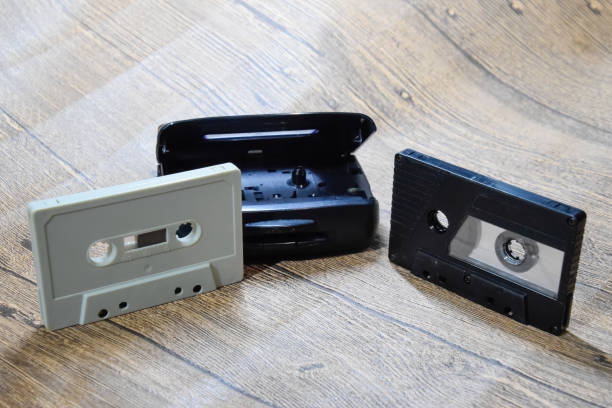 istock Retro audio cassettes next to a portable player to play compact cassettes. 1370960094