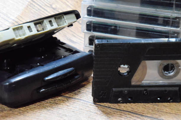 istock Retro audio cassettes next to a portable player to play compact cassettes. 1370960095